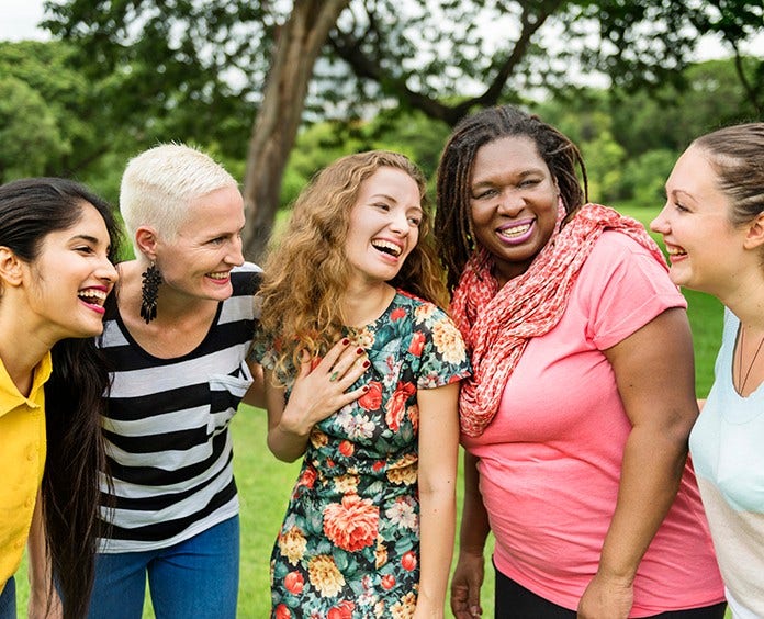 diverse group of women laugh together outside