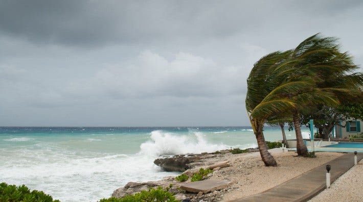 the Caribbean coastline of Grand Cayman being battered by a hurricane