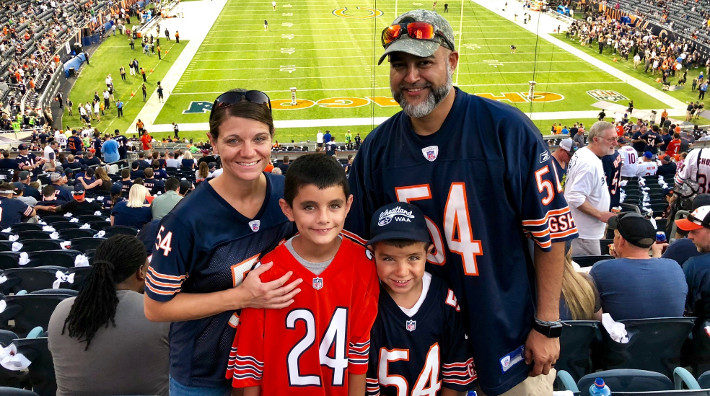 cancer survivor, Roy Arredonda and his family at a football game