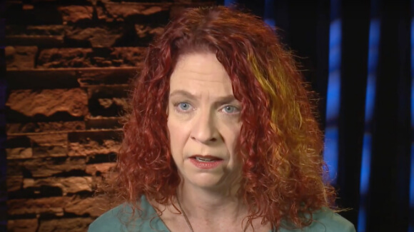 caucasian female with red hair talking during interview
