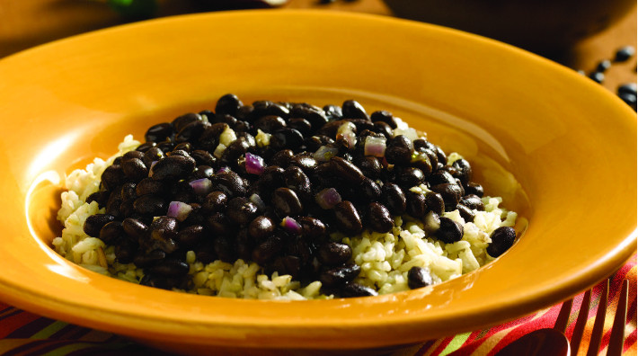 yellow bowl full of Cuban-style black beans and rice