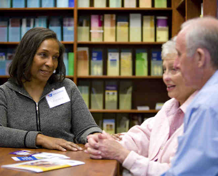 Volunteer assists patients in a cancer resource center