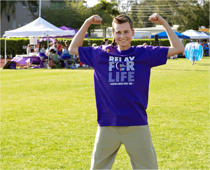 Cole Eicher flexing muscles at an outdoor event