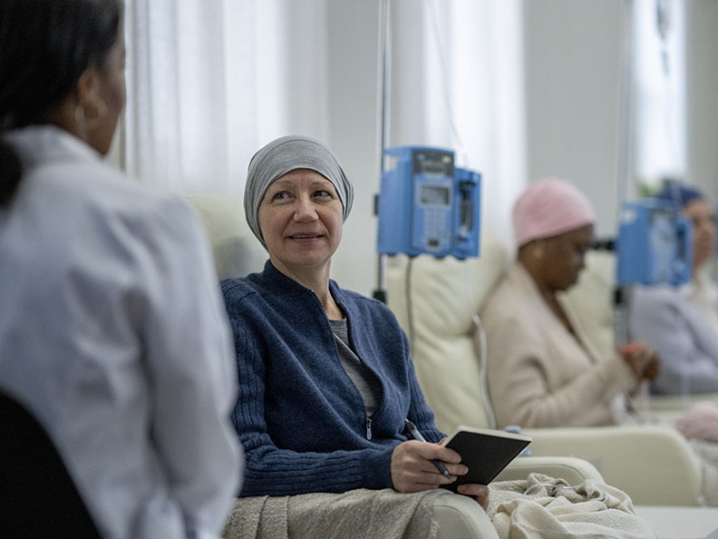 woman sitting in chair during chemotherapy treatment